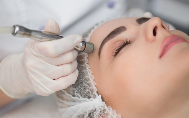 Diamond microdermabrasion, peeling cosmetic. woman during a microdermabrasion treatment in beauty salon